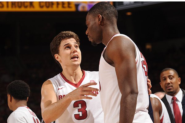 Arkansas guard Dusty Hannahs (3) talks to teammate Moses Kingsley following a timeout during a game against Vanderbilt on Tuesday, Feb. 7, 2017, in Fayetteville. 