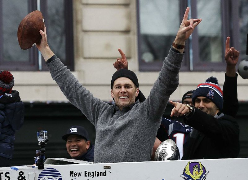 New England Patriots quarterbacks Tom Brady and Jimmy Garoppolo, right, wave during a parade Tuesday, Feb. 7, 2017, in Boston to celebrate their 34-28 win over the Atlanta Falcons in Sunday's NFL Super Bowl 51 football game in Houston. 