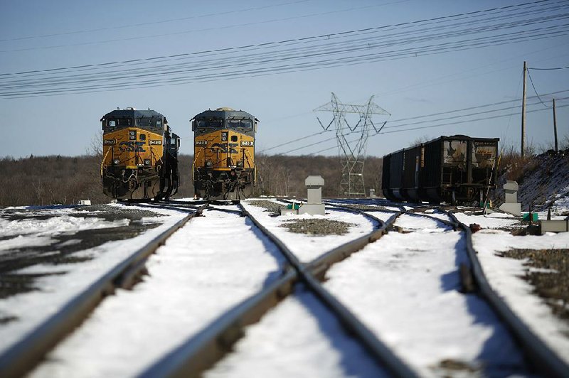 Locomotives sit parked near the Mount Storm coal-fired power-generating plant in West Virginia. Cleaner power sources are replacing coal-fired plants. 
