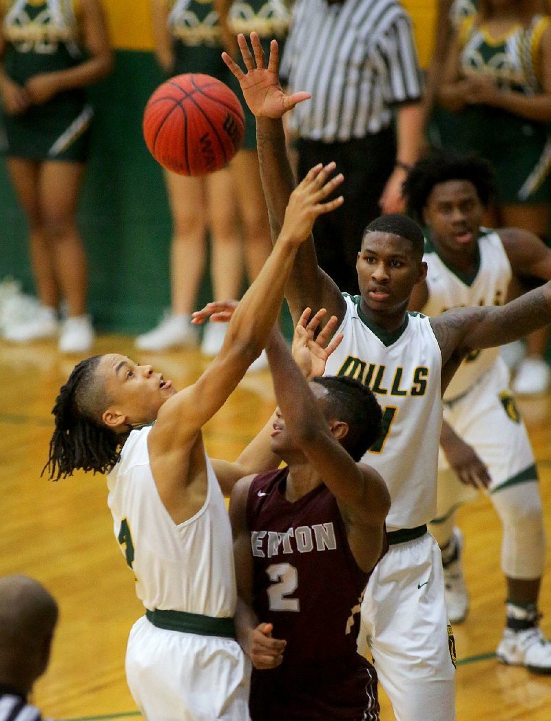 Grehlon Easter (left) and Darious Hall of Mills apply pressure on Benton’s Jai Peters (2) as he tries to pass the ball during the Comets’ 59-49 victory over the Panthers on Tuesday.