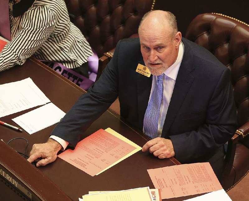 Rep. Mark McElroy, D-Tillar, votes Tuesday on a bill he sponsored to allow installation and operation of cameras on school buses to document traffic violations by other vehicles around the buses. The measure, House Bill 1144, was approved 88-1. 
