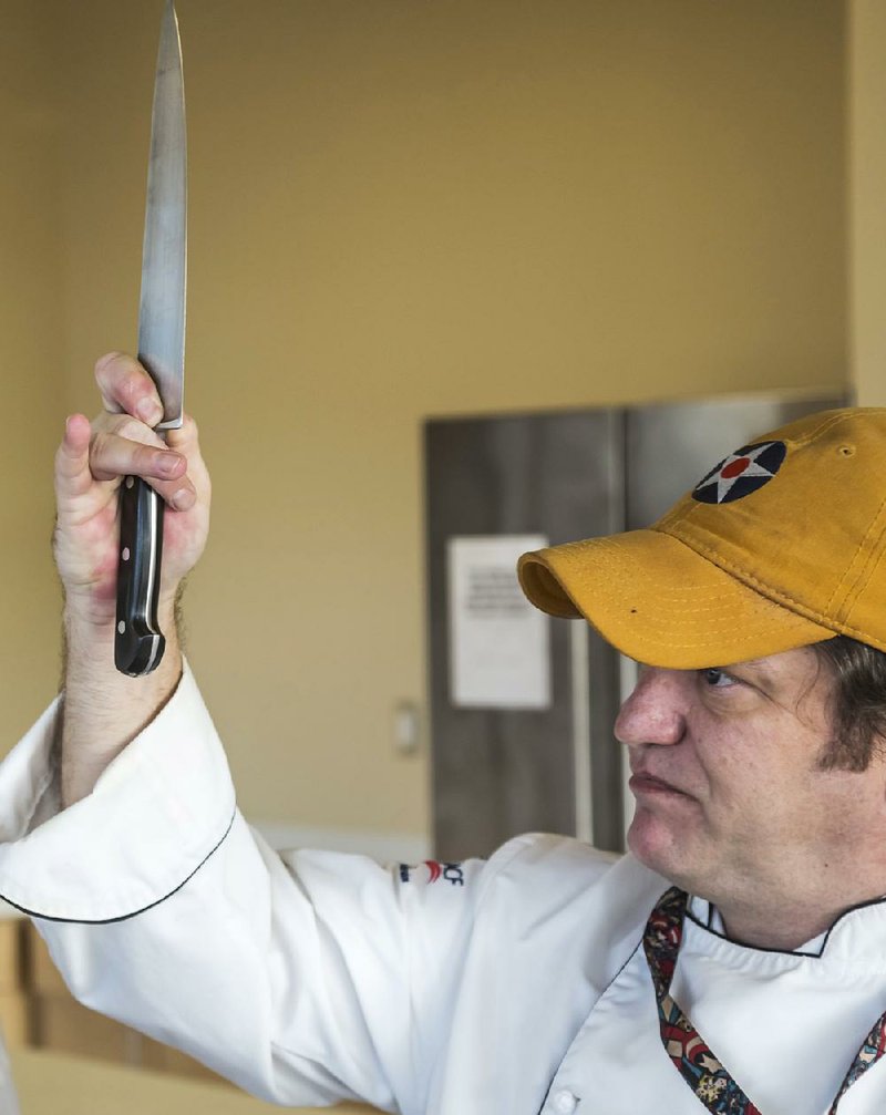 Pulaski Technical College Culinary Arts and Hospitality Management Institute instructor chef Billy Ginocchio demonstrates the proper grip when holding a chef’s knife.