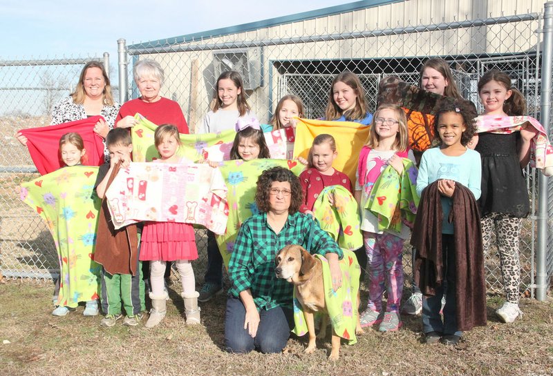 LYNN KUTTER ENTERPRISE-LEADER A girls&#8217; sewing group at Prairie Grove United Methodist Church made 25 fleece blankets and donated them to the Prairie Grove Pound. Girls in the sewing class are Aubrey Ault, Kaylee Cooper, Finley Dick, Brinley Dobbs, Sadie Gastineau, Reese Light, Olivia Lingle, Melindah Newman and Samantha Phelan. Their teachers are Dianne Meissinger, Peggy Hatfield, Elizabeth Lingle, Susan Logan and Cathy Stumbaugh. Also pictured are siblings, Nathan Lingle, Emma Lingle and Kinley Ault.