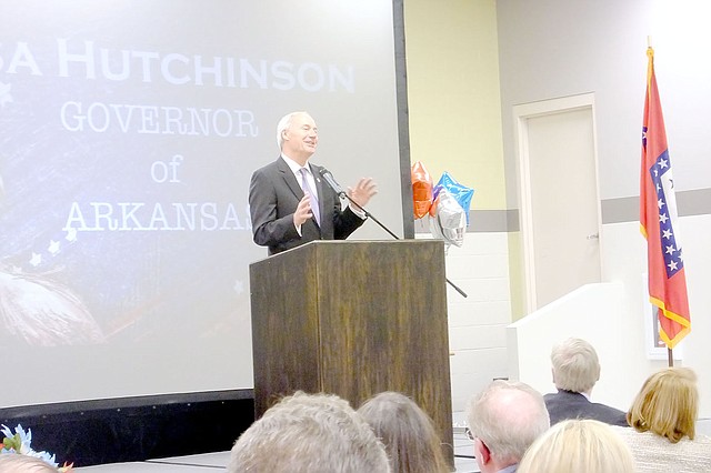 Lynn Atkins/
Governor Asa Hutchinson introduced his long time colleague Mike Hutchinson to the Republicans gathered for dinner at Pea Ridge High School last week. 