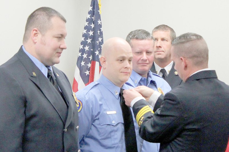 Keith Bryant/The Weekly Vista Freshly-promoted Capt. Brian Lasiter, left, stands with Capt. Leon Lieutard and Capt. Jason Bowman, while battalion chief Robert Hamilton pins Lieutard&#8217;s new Brass and deputy chief Bryan Wolfgang, background, stands by.
