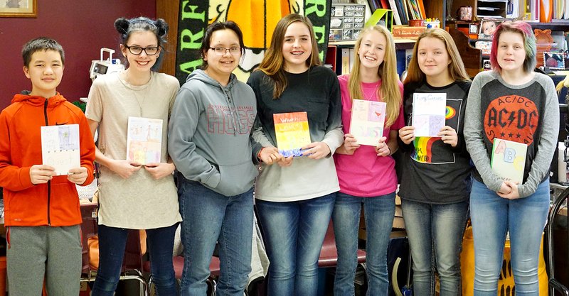 Photo by Randy Moll Members of Sammie Cunningham&#8217;s Quest Class at Gentry Middle School - Zongca Moua, Emaly Wilkins, Martha Smith-Gomez, Emily Jessen, Brooke Blevins, Naomi Brinkley and Amy Eckart - show books they wrote and will give to Washington Regional Cancert Support Home on Friday, Feb. 17, 2017, to help children cope with cancer and cancer treatments.