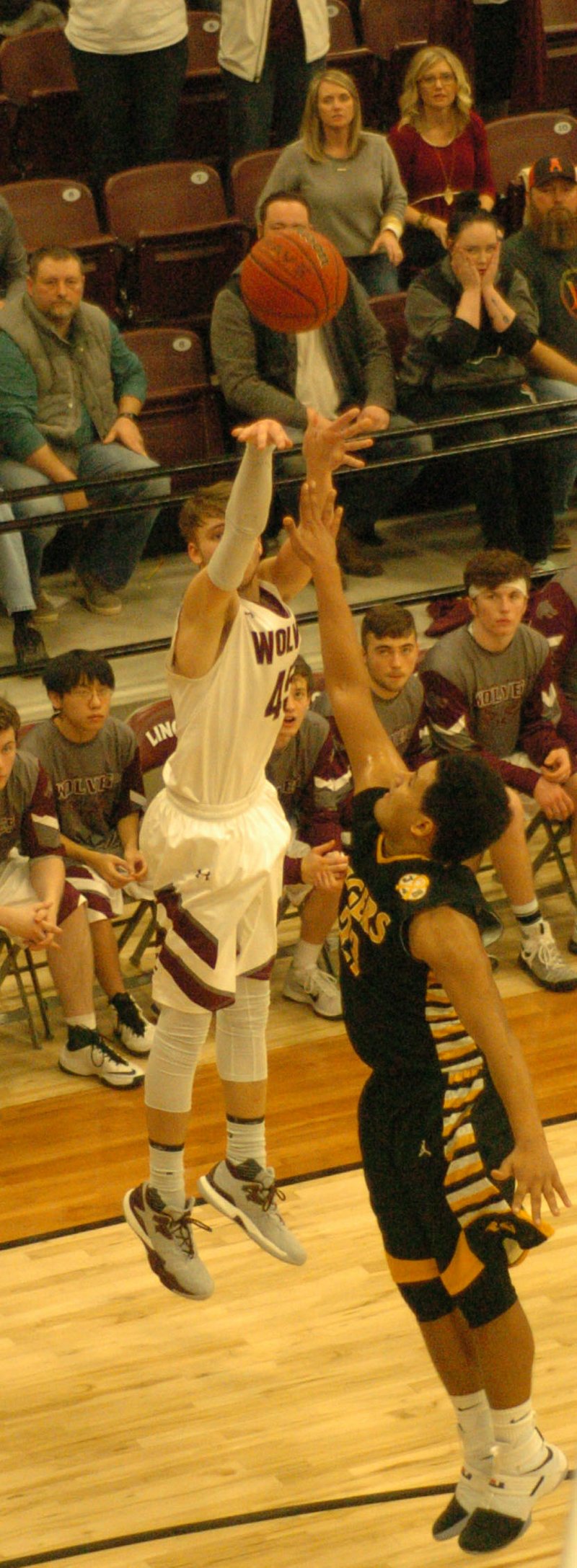 MARK HUMPHREY ENTERPRISE-LEADER Game-winner. Lincoln forward Troy Sugg hit this 3-point shot over a Prairie Grove defender with 9.2 seconds left to lift the Wolves to an exciting 53-52 come-from-behind win at home over the Tigers Friday. Sugg scored all 14 of his points in the second half.