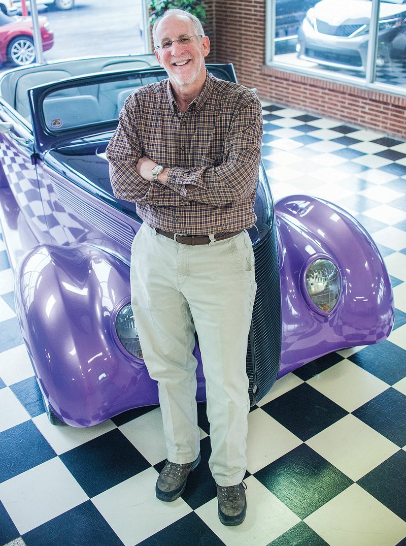 Jamie Sorrells, president and co-owner of Sorrells Body Shop in Russellville, leans on a car in the showroom of the business, which his father started. Sorrells, who has worked for XTO Energy since 1981, was named Citizen of the Year in January by the Russellville Area Chamber of Commerce.