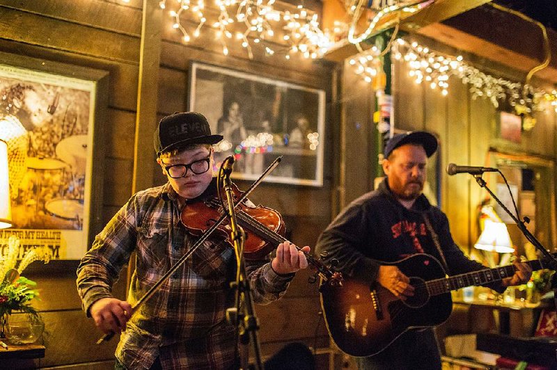 Gus Kerby (left) will help out his singer-songwriter dad Kevin (right) Friday at The Undercroft performance space in the basement of Christ Episcopal Church in downtown Little Rock. 