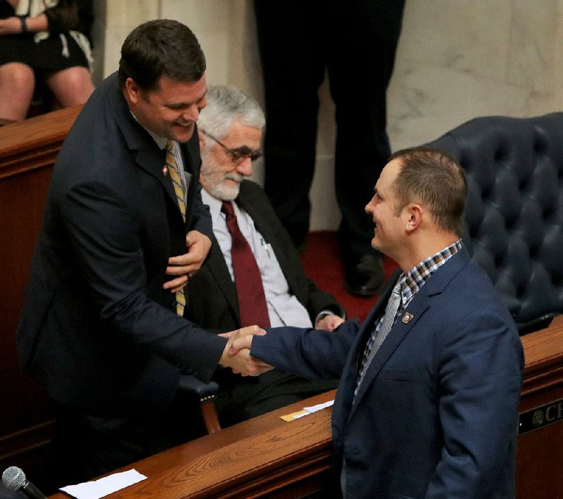 Sen. Bart Hester (left) is congratulated by Sen. Trent Garner on Wednesday after Hester’s bill to allow grocery stores to seek permits to sell wine from any winery was approved by the Senate State Agencies and Governmental Affairs Committee. 