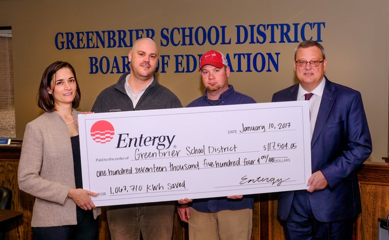 Courtesy photo Ashley Peterson (from left) of Entergy, Josh Gotcher of CLEAResult and Jason Lane of Entergy present $117,504.05 incentive check to Scott Spainhour, superintendent of the Greenbrier School District. Energy efficiency incentives from Entergy Arkansas helped the school district save money by reducing the amount of electricity required for operations, resulted in the check for upgrading nearly all of the district's lighting to LED.