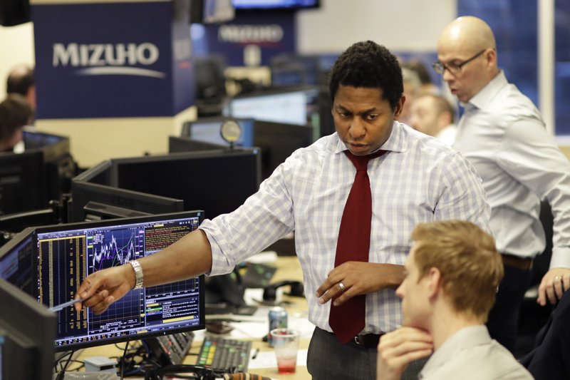 In this Jan. 12, 2017, photo, traders work on the Mizuho Americas trading floor in New York. Stocks are opening slightly lower on Wall Street, Wednesday, Feb. 8, 2017, a day after the Nasdaq composite notched another record high. (AP Photo/Mark Lennihan)