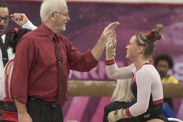 Arkansas head coach Mark Cook congratulates Mia Bargiacchi on her floor routine against Missouri Friday, Jan. 13, 2017 at Barnhill Arena in Fayetteville.