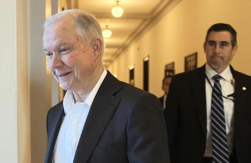 Sen. Jeff Sessions (left) leaves his office on Capitol Hill early Wednesday before the Senate’s 52-47 vote approving him as attorney general after a rancorous confi rmation process. 