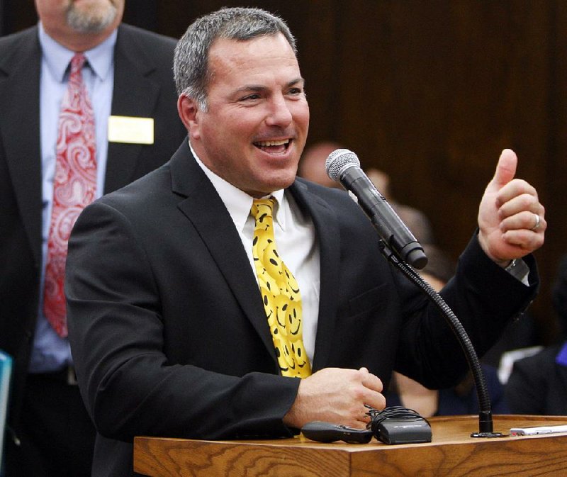 Blytheville Superintendent Richard Atwill gives a thumbs-up Thursday after the state Board of Education removed his school district from the academic-distress list.