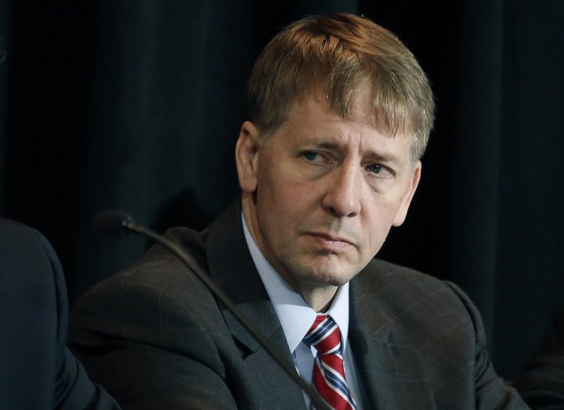 In this Wednesday, Oct. 7, 2015, file photo, Consumer Financial Protection Bureau Director Richard Cordray listens to a speaker during a a hearing in Denver. 
