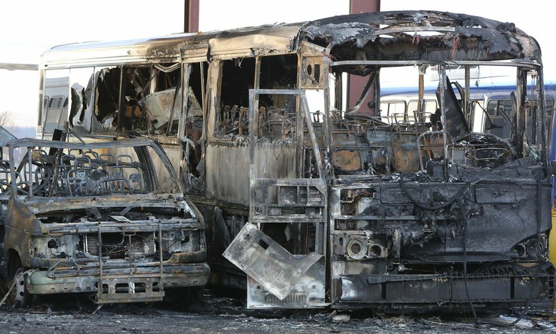 File Photo/NWA Democrat-Gazette/DAVID GOTTSCHALK  The remains of destroyed buses sit Jan. 10 under the bus canopy at Ozark Regional Transit in Springdale. Twenty busses were destroyed in the fire that started around 1 a.m. 