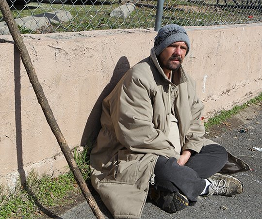 The Sentinel-Record/Richard Rasmussen HOMELESS: A homeless man who declined to give his name waits near the Jackson House on Malvern Avenue for a free lunch on Thursday. The man said he lives in a camp in Hot Springs and has been homeless for about seven or eight years.