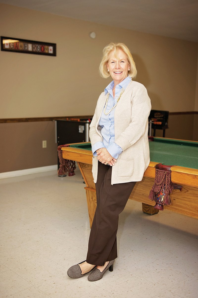 Donna Robertson leans on a pool table in the recreation room at the Conway branch of Birch Tree Communities, a residential program for people with severe mental illness. Robertson, co-director of the branch, was named in December by the Conway Area Chamber of Commerce as one of two winners of the Women in Business Awards in the nonprofit category.