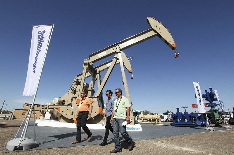 People attend the Permian Basin International Oil Show last year in Odessa, Texas. Drillers have paid as much as $60,000 an acre to tap into the oil-rich Permian Basin. 
