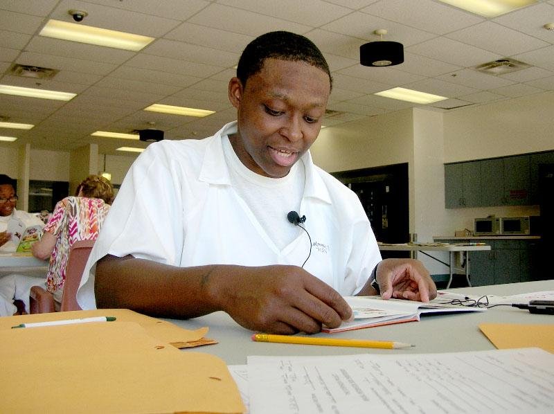 Yochechi Mangrum, an inmate at the Grimes Unit in Newport, reads and records a story as part of the Storybook Project. Volunteers visit the unit a few times a year to record inmates reading to their children or grandchildren. 