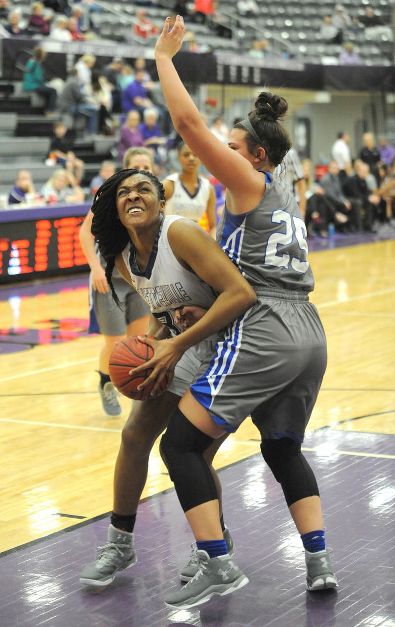 Fayetteville forward Jasmine Franklin (left) attempts to shoot around Rogers forward Madison Sandor on Friday at Bulldog Arena. Visit nwadg.com/photos for more photos from the game.