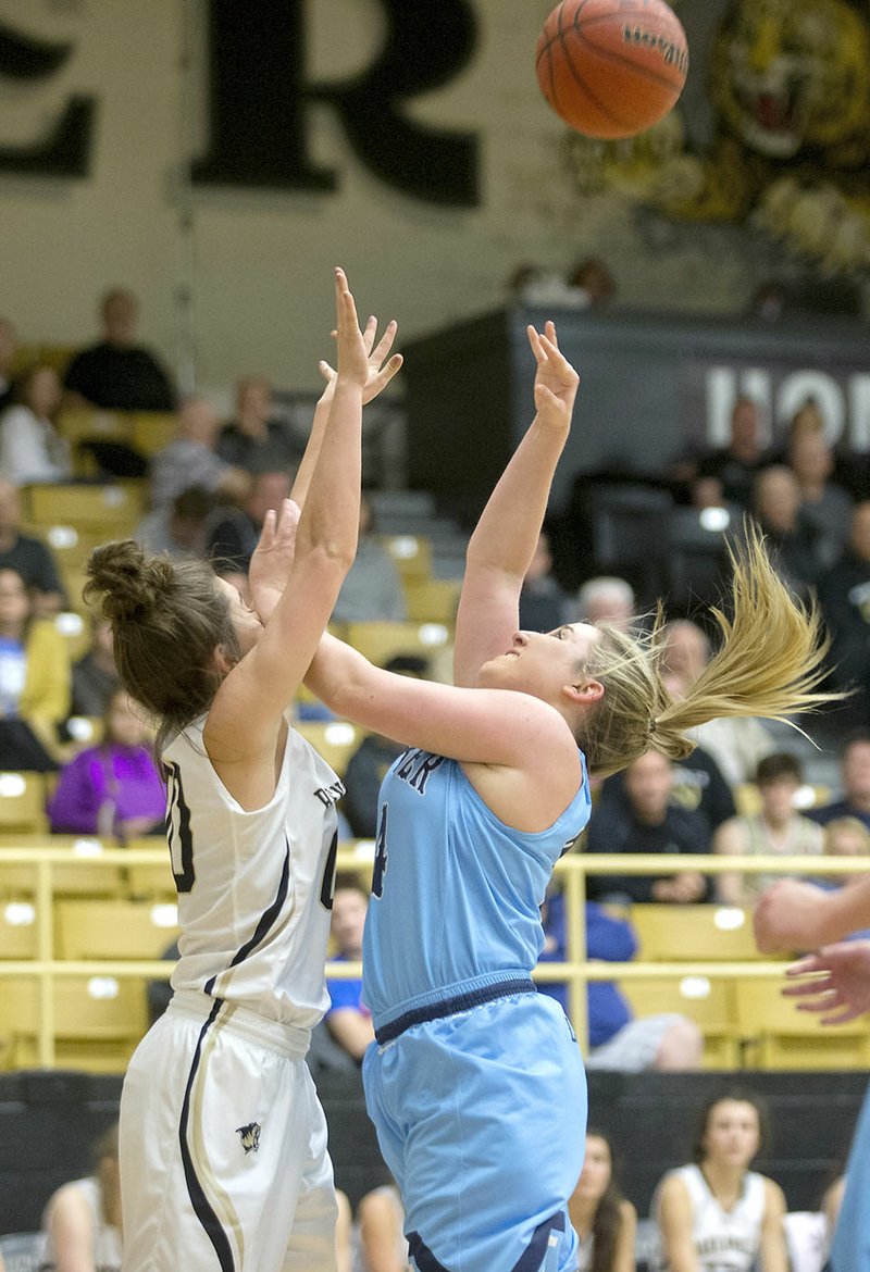 Springdale Har-Ber High junior Maci Mains (right) draws a foul from Bentonville sophomore Avery Hughes on Friday in Bentonville.