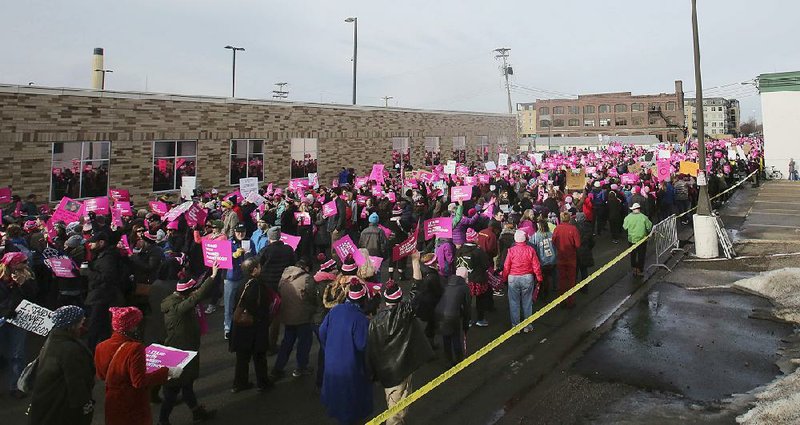 Planned Parenthood supporters march Saturday outside the group’s center in St. Paul, Minn.