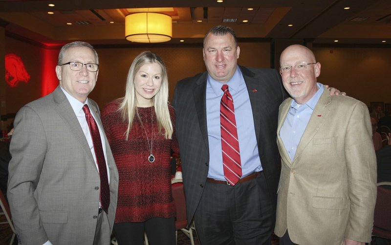 Jeff Long, UA vice chancelor and athletic director (from left), Jen and Razorback football head coach Bret Bieleman, and “The voice of the Razorbacks” Chuck Barrett gather for a photo at “Signing Day on the Hill” on
Feb. 2 at the Holiday Inn in Springdale.