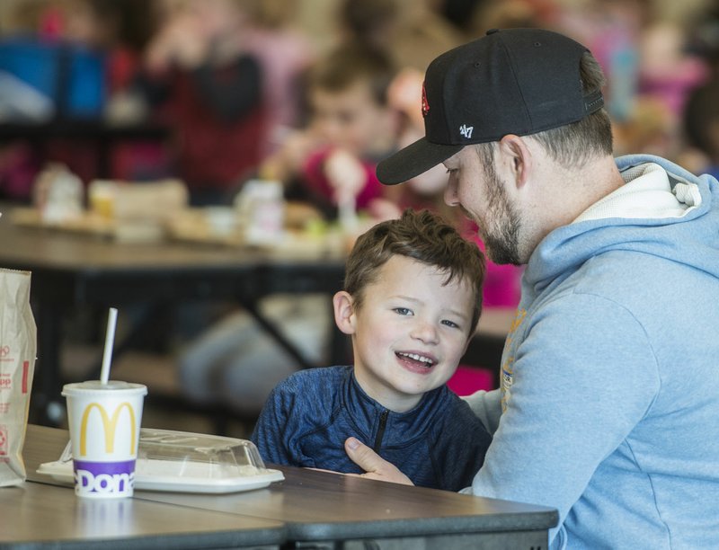 NWA Democrat-Gazette/ANTHONY REYES @NWATONYR John Bennet hugs his son Jude Bennet, 6, Friday, Feb. 3, 2017 after they ate lunch together at Willowbrook Elementary School in Bentonville. Bennet said he or his wife try to come and eat lunch with Jude a couple of times a month. More parents have taken the time to occasionally eat lunch with their children at school.