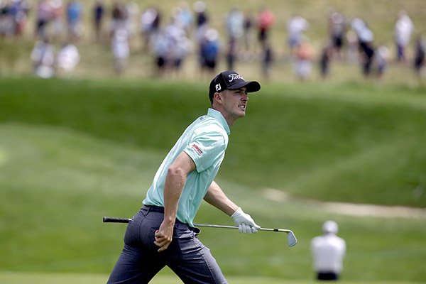 Ethan Tracy watches his shot from rough on the seventh hole during the rain delayed first round of the U.S. Open golf championship at Oakmont Country Club on Friday, June 17, 2016, in Oakmont, Pa. (AP Photo/John Minchillo)

