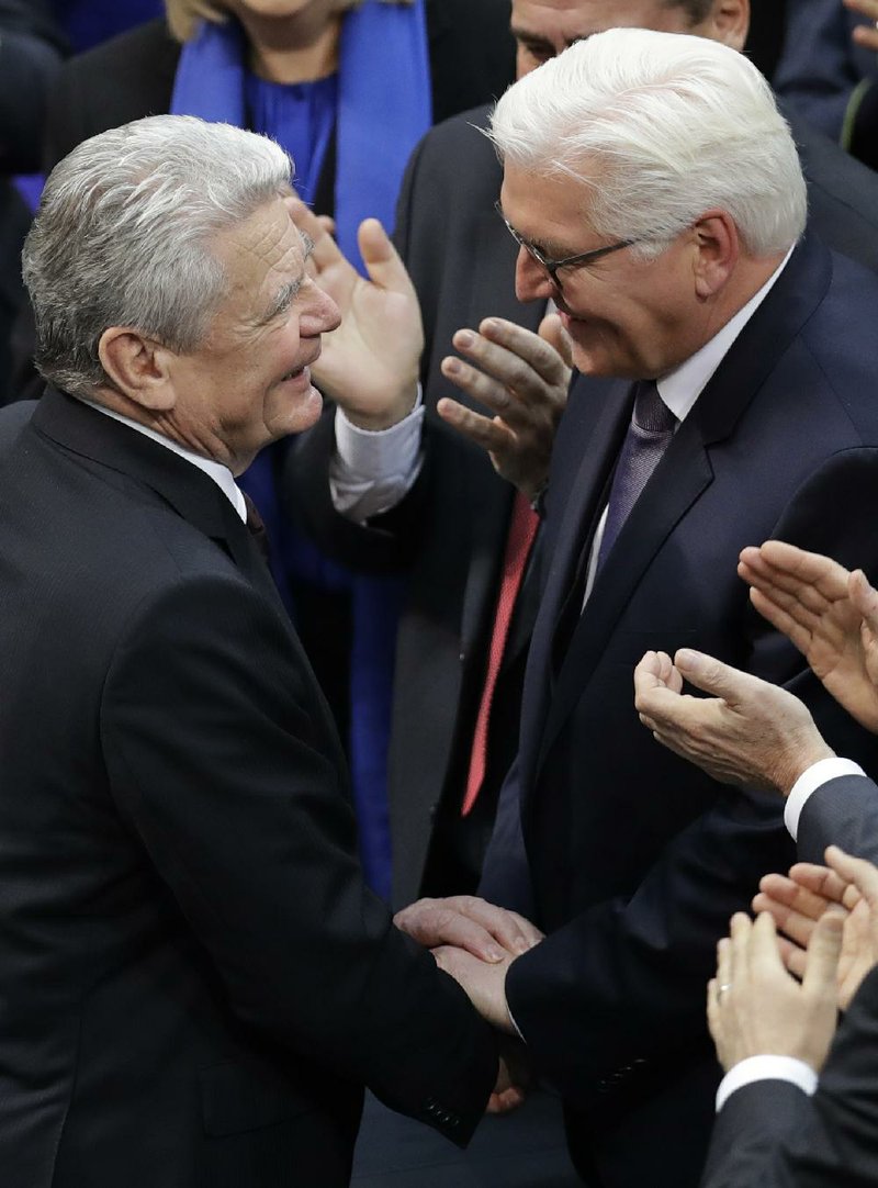 German President Joachim Gauck (left) congratulates President-elect Frank-Walter Steinmeier after a German parliamentary assembly elected the country’s new president Sunday in Berlin.