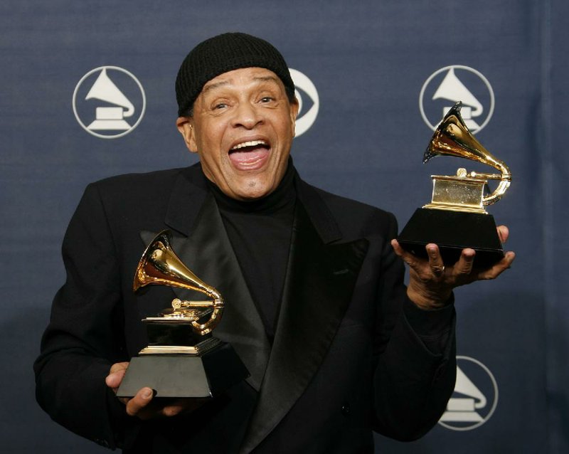 In this Sunday, Feb. 11, 2007, file photo, Al Jarreau poses with his awards for best pop instrumental performance for "Mornin'" and best traditional R&B vocal performance for "God Bless the Child" at the 49th Annual Grammy Awards in Los Angeles.