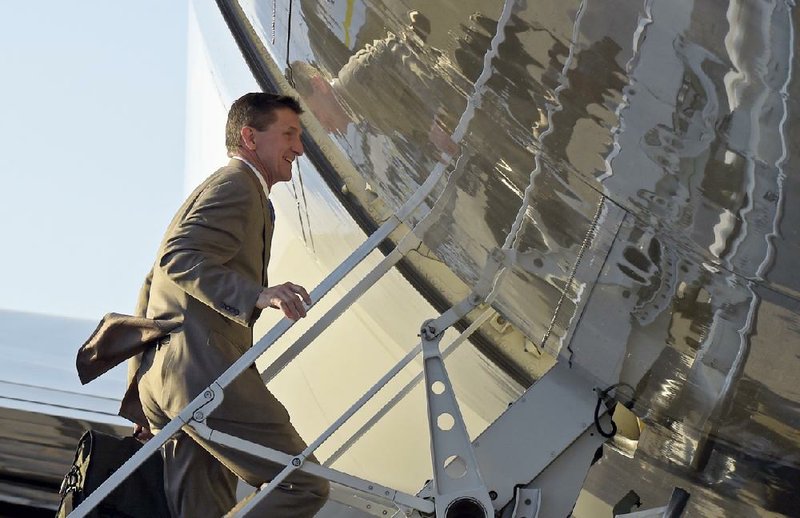 National security adviser Michael Flynn boards Air Force One at Palm Beach International Airport in West Palm Beach, Fla., on Sunday as he returns to Washington with President Donald Trump.