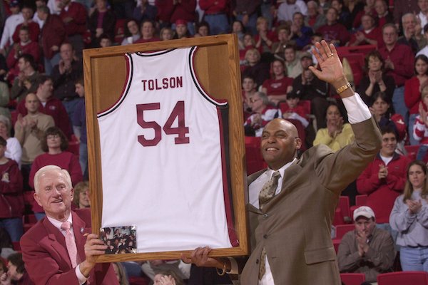 University of Arkansas athletics director Frank Broyles presents Dean Tolson with a framed jersey during halftime of the Arkansas-Mississippi State game Saturday, March 1, 2003, at Bud Walton Arena in Fayetteville.