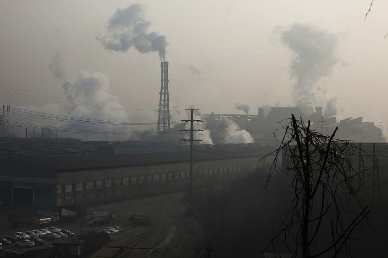 Smoke and steam billow from Jiujiang steel and rolling mills in Qianan in northern China’s Hebei province in December. A new report released Monday said China’s announced reduction in steel production was inaccurate.