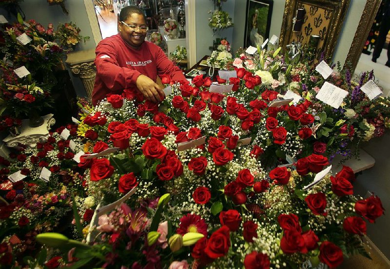 Arkansas Democrat-Gazette/JEFF MITCHELL - 02/13/2016 - Arkansas Democrat-Gazette/JEFF MITCHELL - 02/13/2016 - Kay Morris, an employee of Fairy Tale Forals in North Little Rock, places a personalized message on an arrangement of roses during final preparations for Valentine's Day, February 13, 2017.