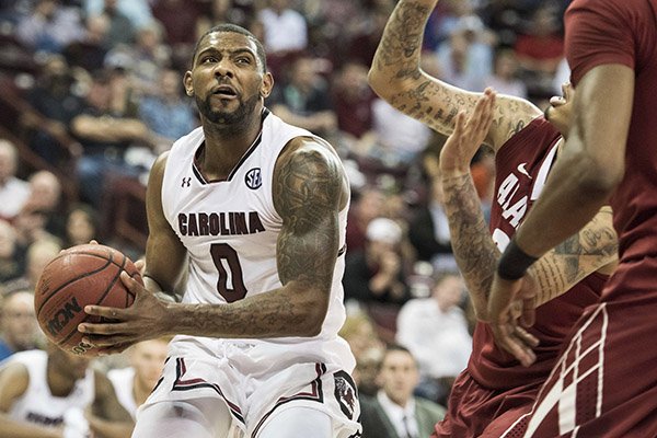 South Carolina guard Sindarius Thornwell (0) drives to the hoop against Alabama guard Ar'Mond Davis, right, during the second half of an NCAA college basketball game Tuesday, Feb. 7, 2017, in Columbia, S.C. Alabama defeated South Carolina 90-86. (AP Photo/Sean Rayford)

