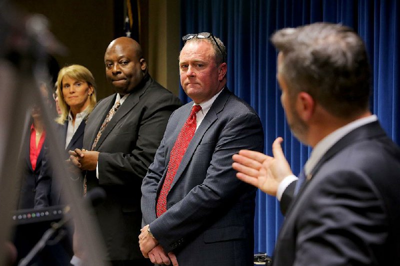Little Rock FBI Special Agent in Charge Diane Upchurch (from left), Little Rock Police Chief Kenton Buckner and U.S. Attorney for the Eastern District of Arkansas Christopher Thyer listen as Jeffrey Reed, resident agent in charge of the ATF, speaks Tuesday in Little Rock about the progress made during the Violence Reduction Network initiative.