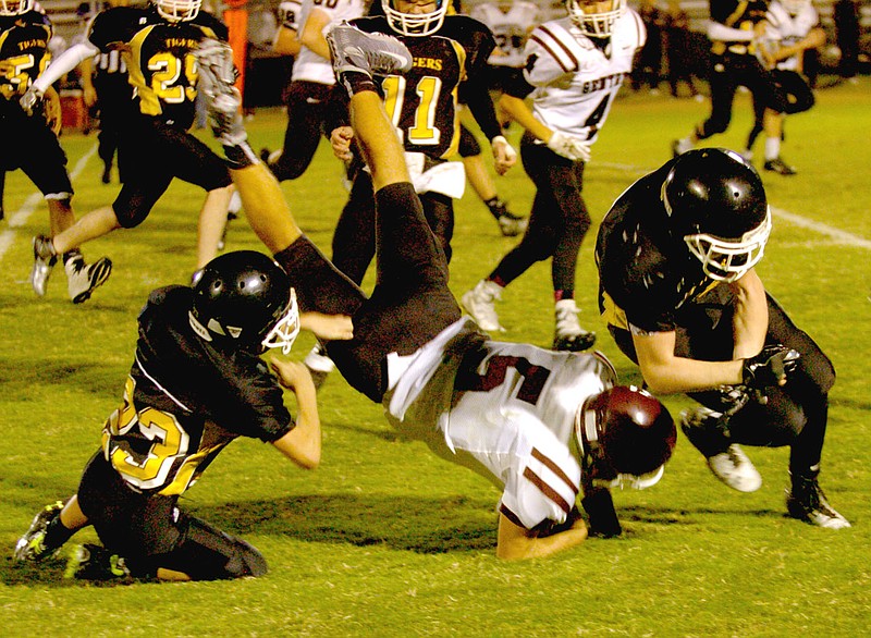 MARK HUMPHREY ENTERPRISE-LEADER Prairie Grove&#8217;s Cody Kruse upends Gentry quarterback Brandon Atwood, forcing a fumble that was recovered by Prairie Grove&#8217;s Jadin Higgins. Officials ruled no fumble and Gentry marched on to score. The junior Pioneers won 32-24.