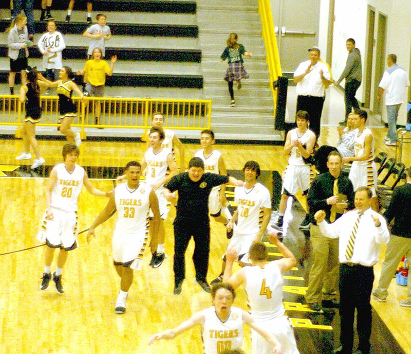 Photo by Mark Humphrey/Enterprise-Leader/Prairie Grove players, coaches and fans celebrate the Tigers&#8217; 59-56 win over Pea Ridge Feb. 7.
