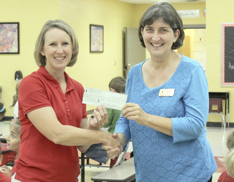 SUBMITTED PHOTO Sheryl Cash, coordinator of the Farmington Stampede, presents a check for $1,875 to Mary Jane Silva for the Back to School Bonanza sponsored by Farmington United Methodist Church.