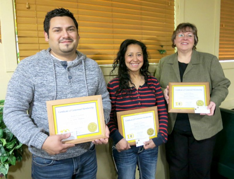 Photo by Susan Holland Three new members of the Gravette Lions Club were inducted in a special ceremony at a breakfast meeting of the club Saturday, Feb. 4. Jeremy Gaytan, Maricela Gaytan and Karen Benson are shown here displaying the special centennial pins and framed membership certificates they received. Bill Mattler, secretary of the Gravette club and zone chairperson, conducted the induction ceremony.