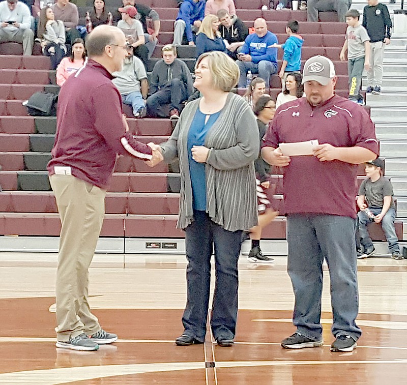 SUBMITTED PHOTO Sandy Anderson with PG Telco presents a check for $1,020 to Deon Birkes, Lincoln schools athletic director, and football coach Don Harrison.