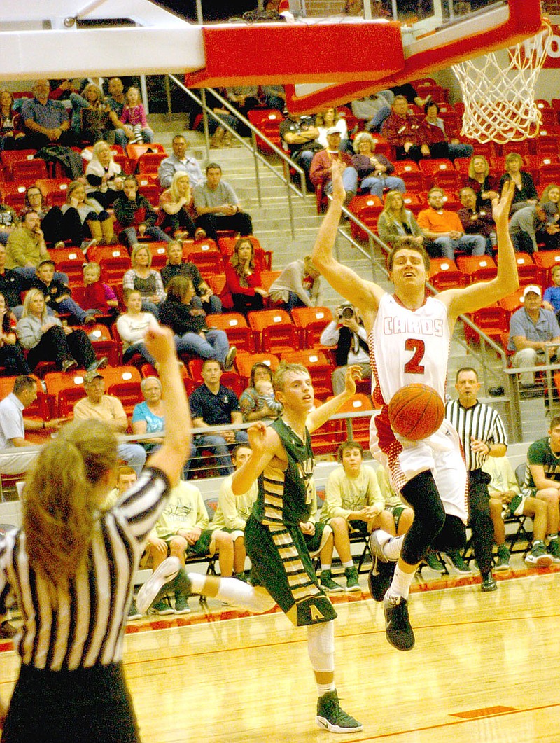 Photo by Mark Humphrey/Enterprise-Leader/Farmington senior Matt Wilson draws a foul while driving to the basket against Alma. Wilson made 11 of 12 free throws Friday on the way to leading the Cardinals to a 70-45 win over Alma.