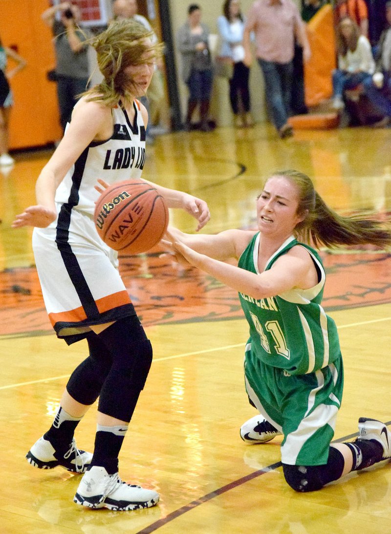 Photo by Mike Eckels Kyrstin Branscum (Gravette 3, left) and Ashlen Rogers (Greeenland 41) fight for possession of a loose ball during the Lady Lions-Lady Pirates basketball contest at the competition gym in Gravette Feb. 10. This contest marked the final home game and the end of the regular season for the Lady Lions.