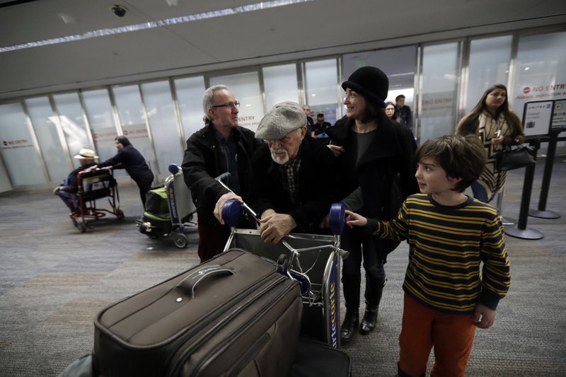 Abdollah Mostafavi (center), arriving from Tehran, Iran, is met by his family — including son-in-law Nasser Sorkhavi (left), daughter Mozhgan Mostafavi (second from right ) and grandson Kourosh Sorkhavi — on Jan. 28 at San Francisco International Airport in San Francisco. Mostafavi was held at the airport for some time as a result of President Donald Trump’s executive order.