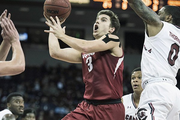 Arkansas guard Dusty Hannahs (3) drives to the hoop against South Carolina guard Sindarius Thornwell (0) during the first half of an NCAA college basketball game, Wednesday, Feb. 15, 2017, in Columbia, S.C. (AP Photo/Sean Rayford)

