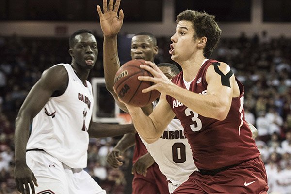 Arkansas guard Dusty Hannahs (3) drives to the hoop against South Carolina guard Sindarius Thornwell (0) during the first half of an NCAA college basketball game Wednesday, Feb. 15, 2017, in Columbia, S.C. Arkansas defeated South Carolina 83-76. (AP Photo/Sean Rayford)

