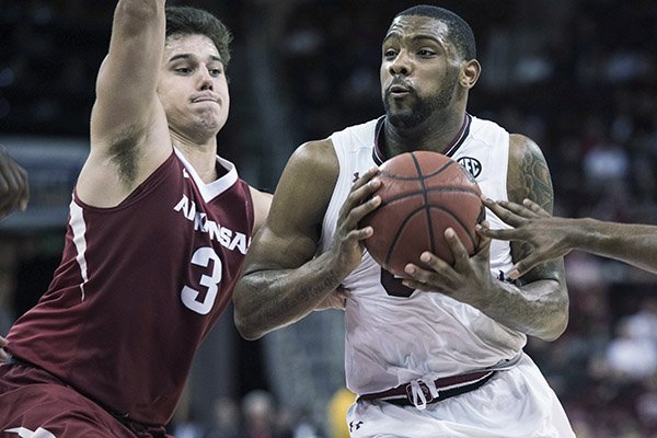 South Carolina guard Sindarius Thornwell, right, drives to the hoop against Arkansas guard Dusty Hannahs (3) during the second half of an NCAA college basketball game Wednesday, Feb. 15, 2017, in Columbia, S.C. Arkansas defeated South Carolina 83-76. (AP Photo/Sean Rayford)

